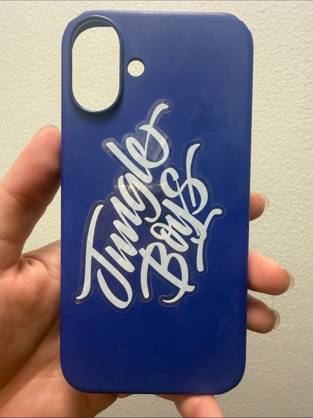 Blue silicone iPhone 16 pro case with white jungle boys sticker on back used